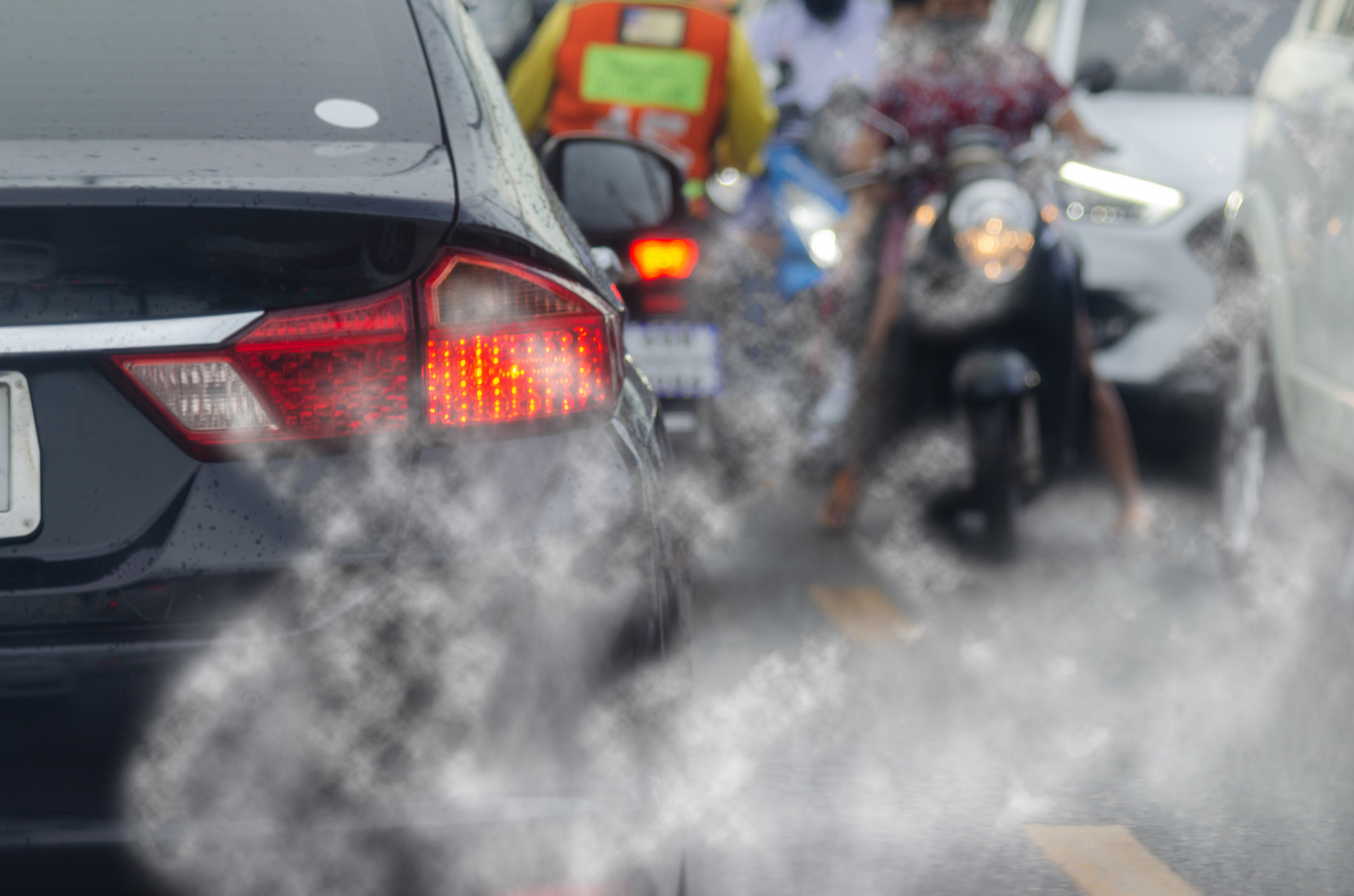 Smoke pollution from car exhaust pipes, traffic jams on the